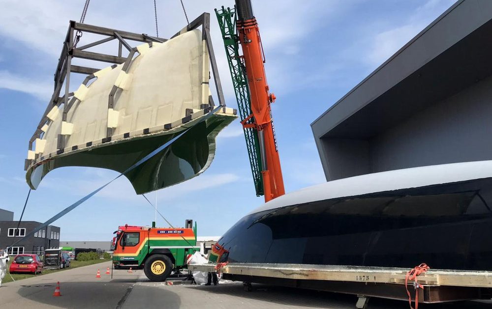 A large hull mould being lifted by crane