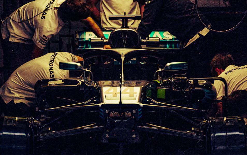 Mechanics working on a Formula 1 car in the garage